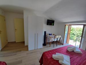 a bedroom with a bed and a dining room with a table at Amoroso's house, affittacamere in Caramanico Terme