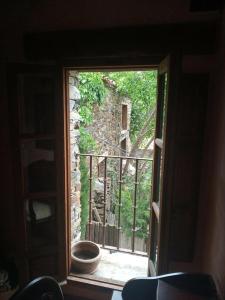 an open window with a view of a stone building at Hotel Rural La Fuente in Patones +34 photos