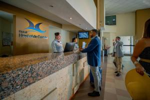 a man standing at a reception counter in a hospital at Hotel Hostal de Cortés in Veracruz +59 photos