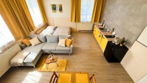 a living room with a couch and a table at Apartmány SVRČINKY in Liptovský Mikuláš