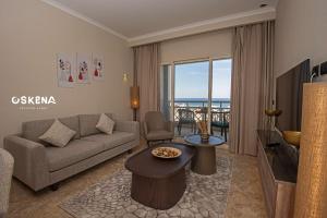 a living room with a couch and a table at OSKENA Azzurra Sahl Hasheesh Hurghada in Hurghada