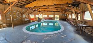 a large swimming pool in a wooden building with a pool at Cabins with a Mountain view 5A in Williams
