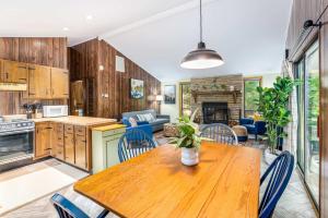 a kitchen and living room with a wooden table and chairs at Modern w Fire Pit Deck, Grill & Hot Tub in Berkeley Springs +28 photos