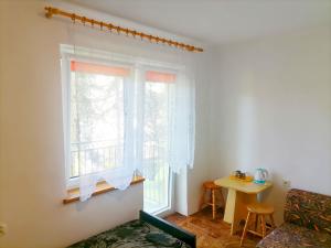 a living room with a window and a table at Dom Gościnny Grażyna in Pobierowo