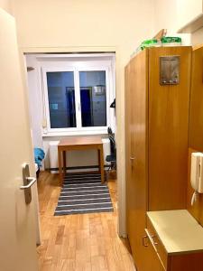 a hallway with a table and a window in a room at Mini Flat in Graz
