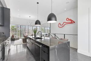 a kitchen with a sink and a counter top at Grand Prix Grandeur at AMP in Dawsonville
