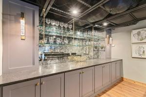 a kitchen with a counter with glasses on the wall at Grand Prix Grandeur at AMP in Dawsonville