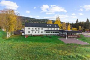 an aerial view of a large white building at Snåsa Hotell in Lerå