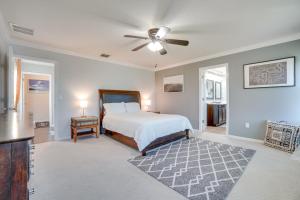 a bedroom with a bed and a ceiling fan at WFH, Relax and Enjoy At-Home Comforts in Orlando in Kissimmee