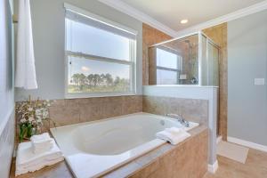 a large bathroom with a tub and a window at WFH, Relax and Enjoy At-Home Comforts in Orlando in Kissimmee +21 photos