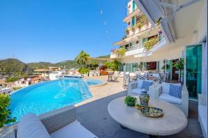 a patio with a table and chairs and a swimming pool at Casa Ivonne in Puerto Vallarta