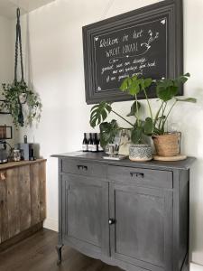 a gray cabinet with plants on top of it at Bed & Breakfast [H]eerlijk! in De Kwakel +33 photos