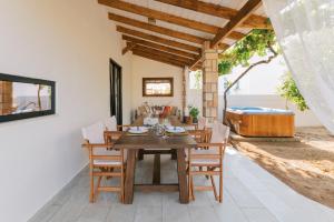 a dining room with a table and chairs at La Casetta della Nonna in Lartos