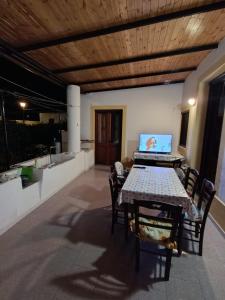a table and chairs with a laptop on a patio at Casa Amena con ampio terrazzo e giardino in Lipari