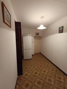 an empty room with a refrigerator and a kitchen at Casa Amena con ampio terrazzo e giardino in Lipari +14 photos
