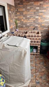 a bathroom with a table and a stone wall at Apto. en zona céntrica con vista panorámica al pueblo in San Gil