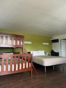 a bedroom with two bunk beds and a ladder at Fisherman's Cove Inn in Monterey
