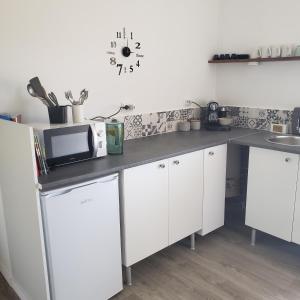 a kitchen with white cabinets and a counter top at Casa Hortensia in Cardigos
