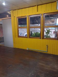 a yellow wall with windows in a room at 362 สวนอ้อย5 in Dusit