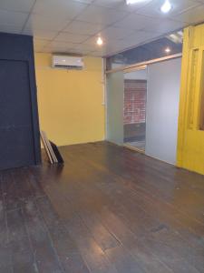 an empty room with yellow walls and a wooden floor at 362 สวนอ้อย5 in Dusit
