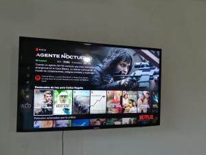 a flat screen tv hanging on a wall at Casa Cayo in Ixtapa +4 photos