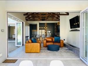 a living room with two couches and a tv at Villa 206 Clarens Golf Estate in Clarens