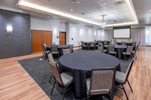 a conference room with tables and chairs and a screen at Drury Plaza Hotel Savannah Pooler in Savannah +54 photos
