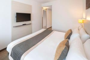 Postel nebo postele na pokoji v ubytování Best Western Colmar Expo