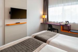 Postel nebo postele na pokoji v ubytování Best Western Colmar Expo