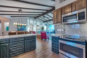 a kitchen with blue cabinets and a living room at Casa Zillori in Puerto Peñasco