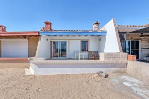 a house on the beach with a table in front of it at La Gaviota in Puerto Peñasco