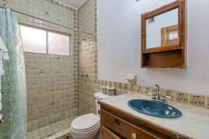 a bathroom with a sink and a toilet and a mirror at La Gaviota in Puerto Peñasco +17 photos