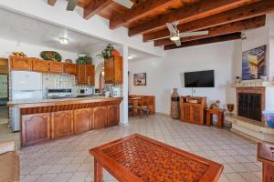 a large kitchen with wooden cabinets and a fireplace at La Gaviota in Puerto Peñasco