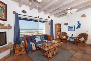 a living room with a couch and a view of the ocean at Buenos Tiempos in Puerto Peñasco
