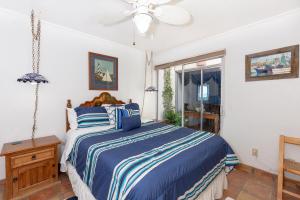 a bedroom with a bed and a ceiling fan at Buenos Tiempos in Puerto Peñasco
