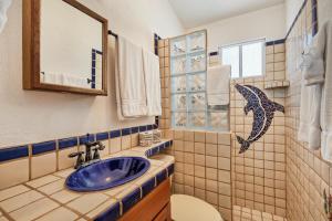 a bathroom with a sink and a toilet and a window at Casita de Suenos in Puerto Peñasco +31 photos