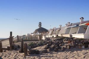 a building on the beach with a pile of rocks at Casa Ole in Puerto Peñasco
