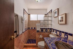 a bathroom with a toilet and a sink at Mariposa in Puerto Peñasco +55 photos