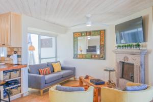 a living room with a couch and a fireplace at Las Olas 1 in Puerto Peñasco