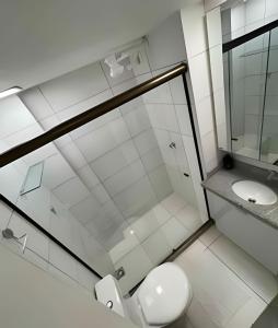a bathroom with a shower and a toilet and a sink at Flat Super Confortável em Porto de Galinhas in Porto De Galinhas
