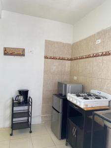 a kitchen with a stove and a stove top oven at Casa cerca del Aeropuerto in Monterrey