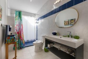 a bathroom with a sink and a toilet and a mirror at La Perla in Playa Encanto +23 photos