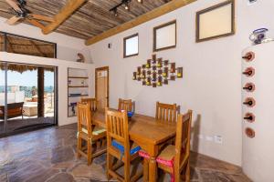a dining room with a wooden table and chairs at Casa en el Cielo in Puerto Peñasco