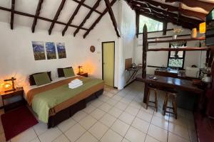 a bedroom with a bed and a desk in a room at La Bella Durmiente in San Alfonso +29 photos