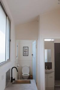 a white bathroom with a sink and a toilet at Sea Haven at Streaky Bay - A Secluded Beach Escape in Perlubie +37 photos
