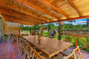 a wooden patio with tables and chairs on a deck at Cabañas Xidó San Miguel in San Miguel de Allende