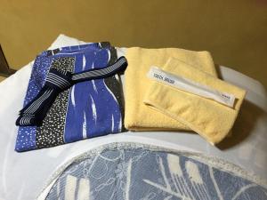 a pair of ties sitting on top of a bed at Kiyotaki Ryokan in Hikone