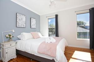 a bedroom with a bed with two towels on it at Queen Street Cottage - By Berry Getaways in Berry