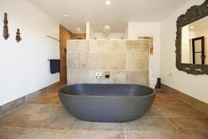 a large tub in a bathroom with a mirror at Allure - By Berry Getaways in Berry +15 photos