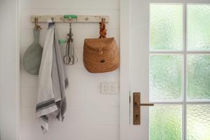 a bathroom with a towel rack and a basket at Fremily Cottage - By Berry Getaways in Berry